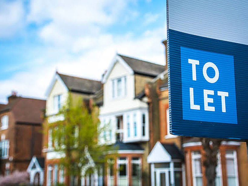 A To Let board outside a row of British houses