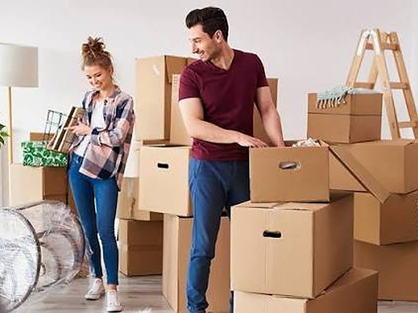 A couple with packing boxes on moving day