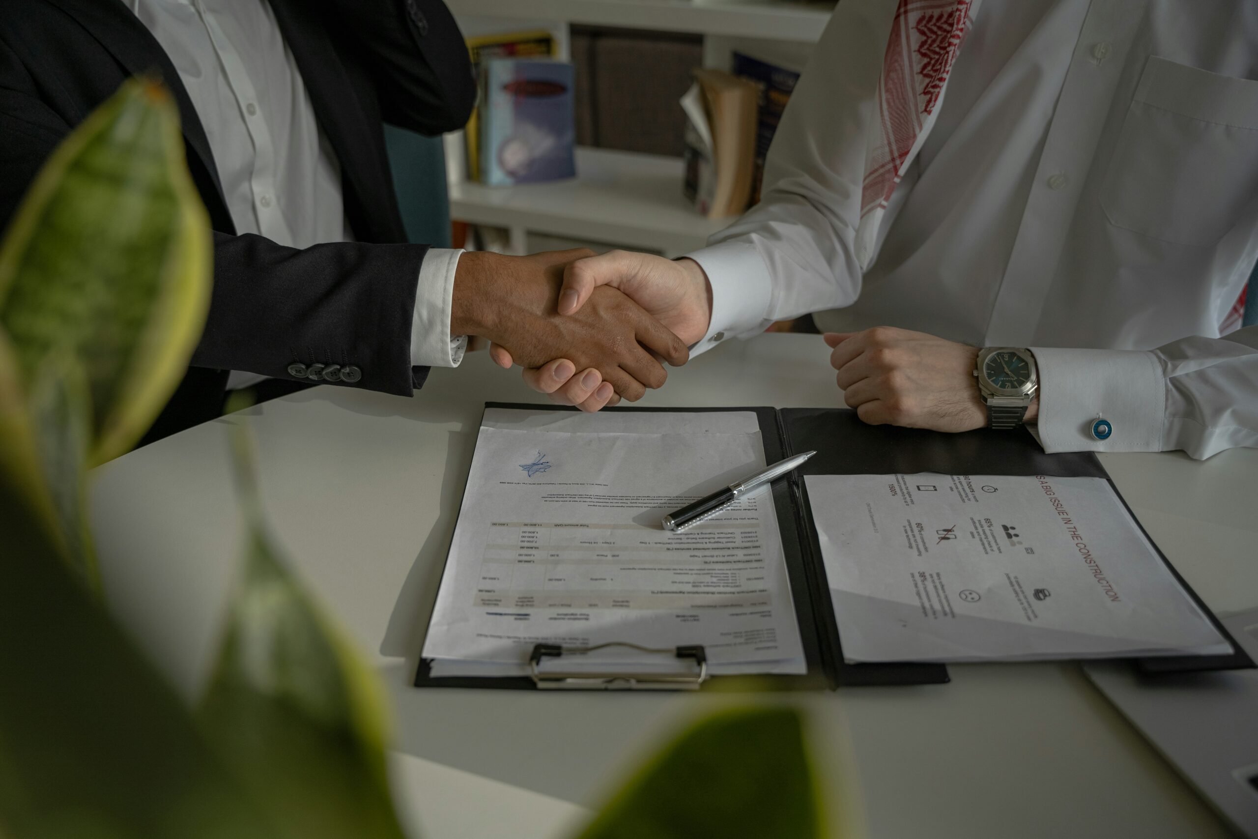 Shaking hands over a signed mortgage agreement